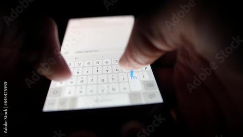 Male Hand Typing on Smartphone Touchscreen Keyboard in the Dark