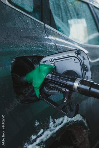 Obraz na płótnie gas pump nozzle in car's fuel tank. w salonie