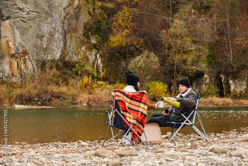 happy couple having picnic at river beach