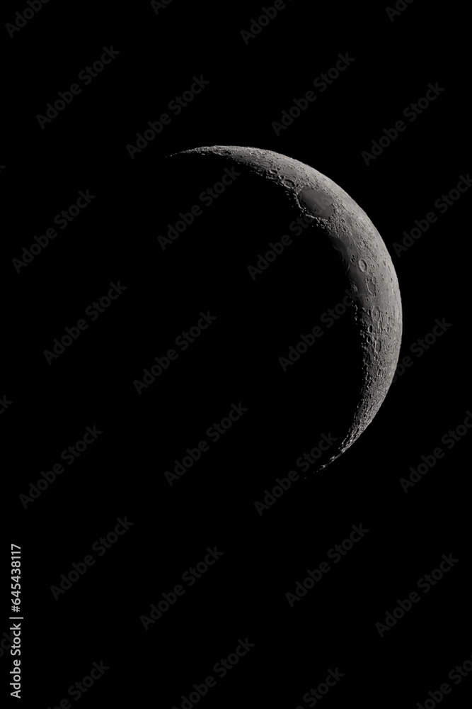 Crescent moon photographed with a telescope, where you can see the craters and the lunar surface, it will soon be a moon landing site Crescent moon photographed with a telescope, where you can see the craters and the lunar surface, it will soon be a moon landing site