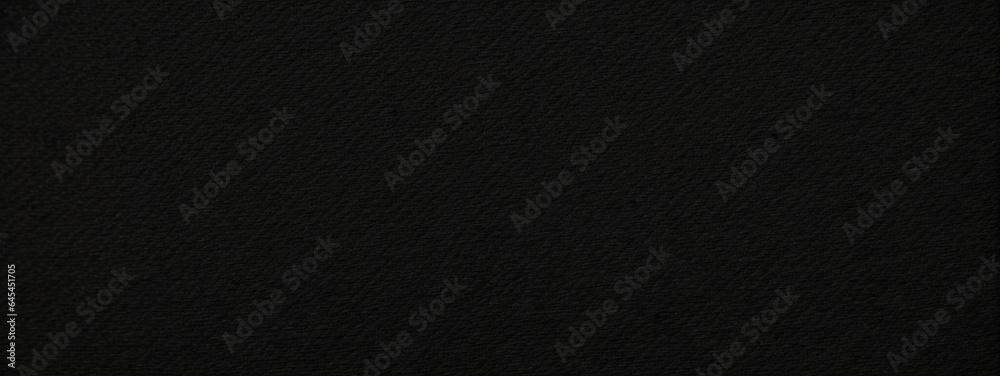 Panoramic close-up texture of natural weave cloth in dark and black color. Fabric texture of natural cotton or linen textile material. Black fabric wide background.