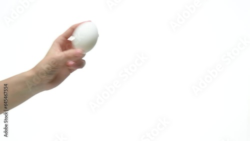Woman female hand showing egg on white background isolation