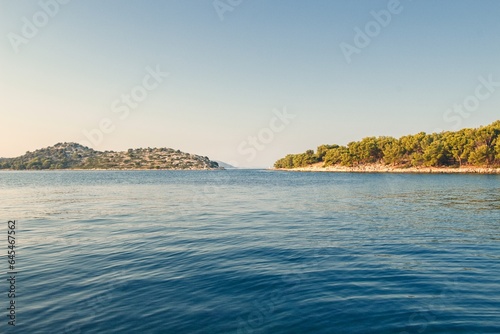 View from the idyllic fishing village Tribunj to small islands in the background during sunset, Croatia, Europe