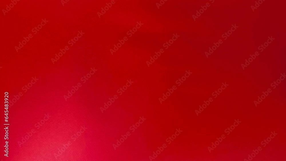 Flatlay with cosmetics arranged around the perimeter: perfumes, eyeshadows, lip gloss, makeup brush, mascara, and lipstick on a bright red background Flatlay with cosmetics arranged around the perimeter: perfumes, eyeshadows, lip gloss, makeup brush, mascara, and lipstick on a bright red background