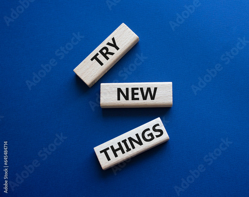 Try new Things symbol. Concept words Try new Things on wooden blocks. Beautiful deep blue background. Business and Try new Things concept. Copy space.