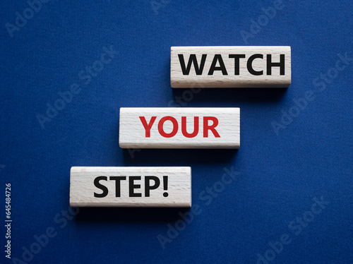 Watch your Step symbol. Concept words Watch your Step on wooden blocks. Beautiful deep blue background. Business and Watch your Step concept. Copy space.