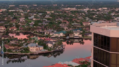 Aerial zoom shot of the bay and buildings in the city of Naples, Florida on sunset time photo