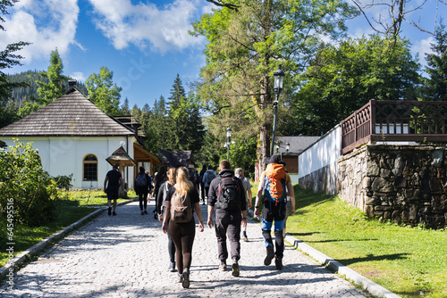 Tourist travelers go hiking in the Tatra Mountains in Zakopane, Poland, on a summer day.