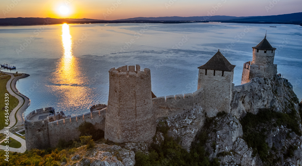 Golubac fortress castle walls standing on Danube river bank in  sunset rays aerial panorama, Serbia