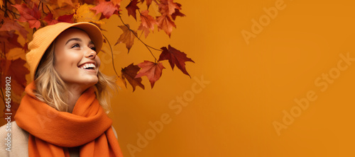 Young Woman in Fall/Autumn Clothes on an Orange Banner with Space fro Copy