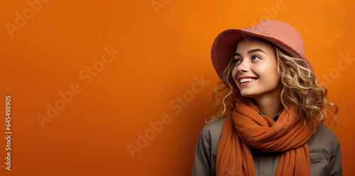 Young Woman in Fall/Autumn Clothes on an Orange Banner with Space fro Copy