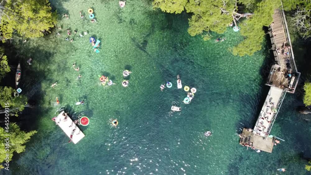 90-degree aerial view people jumping off the deck, swimming, floating ...