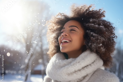 close-up of young black woman with scarf in a beautiful snowy landscape with copy space