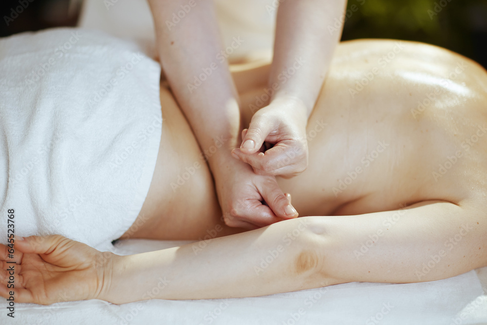 Closeup on medical massage therapist do therapeutic massage Closeup on medical massage therapist do therapeutic massage