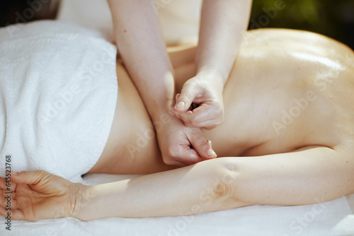 Closeup on medical massage therapist do therapeutic massage