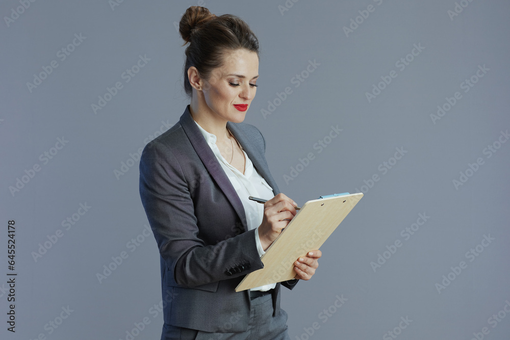 trendy woman worker in gray suit isolated on grey trendy woman worker in gray suit isolated on grey