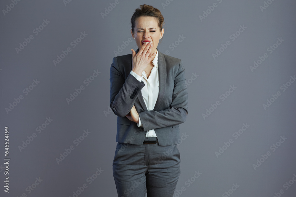 tired woman employee yawing isolated on gray background tired woman employee yawing isolated on gray background