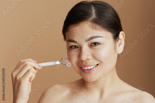 modern asian woman with roller massager
