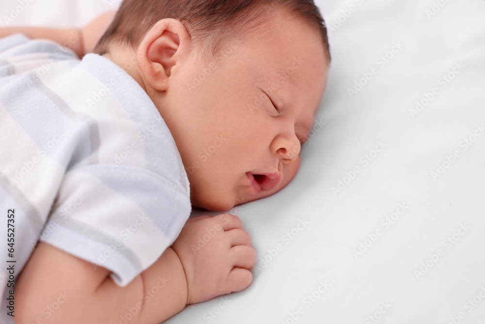 Cute newborn baby sleeping on white bed, closeup. Space for text Cute newborn baby sleeping on white bed, closeup. Space for text