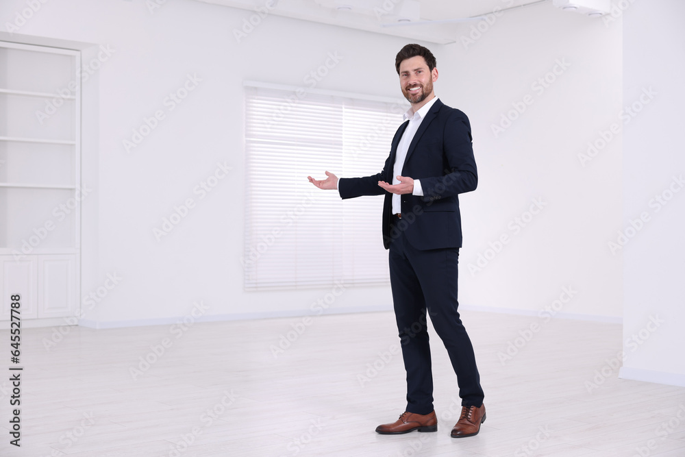 Happy real estate agent showing new apartment Happy real estate agent showing new apartment