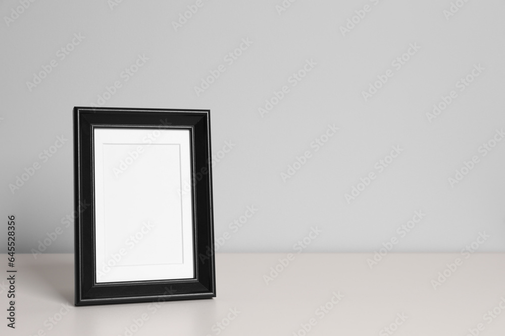 Empty square frame on white table, space for text Empty square frame on white table, space for text
