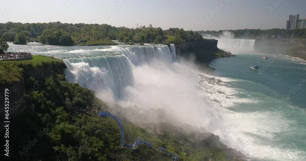 Panorama of huge water flows down the waterfall, boats on the river, Niagara Falls Panorama of huge water flows down the waterfall, boats on the river, Niagara Falls