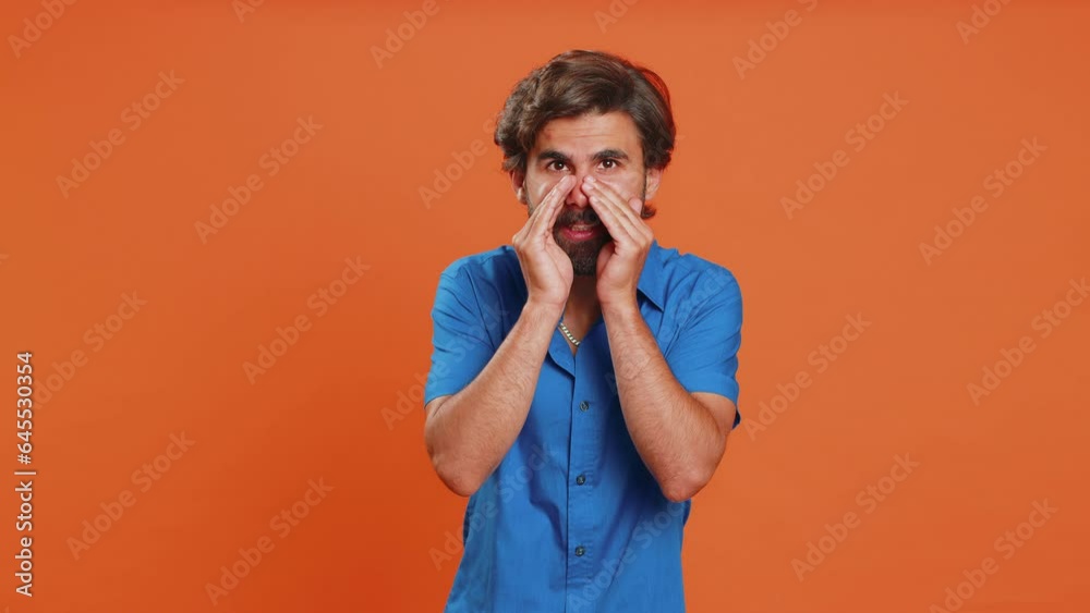 Keep my secrets, silence. Man whisper news rumors holding hands near mouth share gossip, quiet. Middle eastern guy in shirt telling interesting confidential story isolated on orange studio background Keep my secrets, silence. Man whisper news rumors holding hands near mouth share gossip, quiet. Middle eastern guy in shirt telling interesting confidential story isolated on orange studio background
