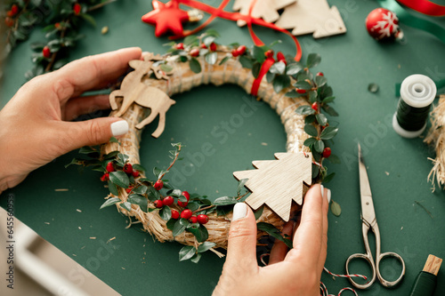 Woman holding Christmas wreath in hands