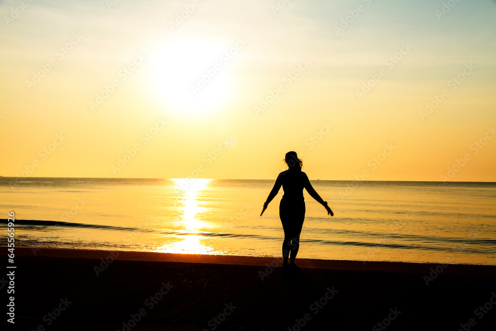 Woman exercise with sunrise at beach Bang Boet Woman exercise with sunrise at beach Bang Boet