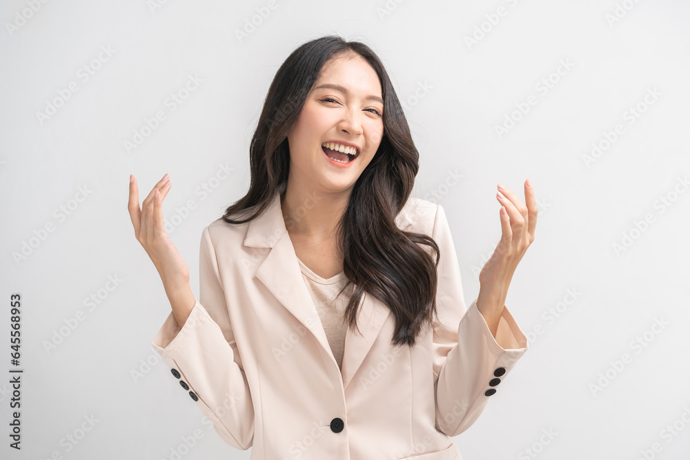 Smiling positive, attractive asian young woman, girl in beige suit formal dress, portrait elegant of pretty with long black hair, feeling happy looking at camera standing isolated on white background. Smiling positive, attractive asian young woman, girl in beige suit formal dress, portrait elegant of pretty with long black hair, feeling happy looking at camera standing isolated on white background.