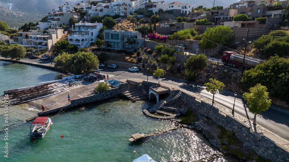 panoramic view of the sea bay with boats and ancient buildings on the island of Crete filmed from a drone