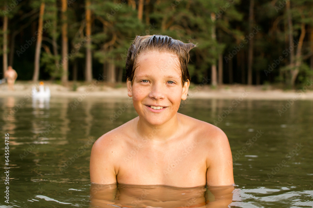 Fototapeta premium Camping weekend, teenage boy, lake and sandy shore.