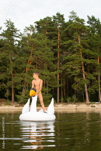 Outdoor recreation with family, child playing with inflatable swan.