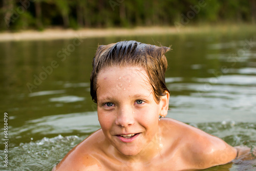 Camping weekend, teenage boy, lake and sandy shore.