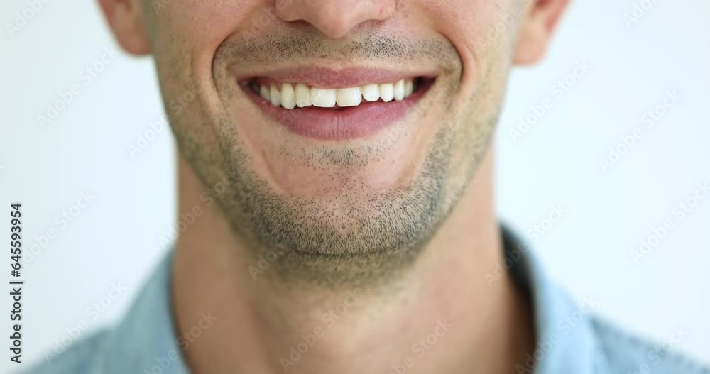 Close up cropped view lower part of unrecognizable young male face, happy guy having wide white-toothed smile, advertising professional dental services, showing optimistic mood and positive emotions Close up cropped view lower part of unrecognizable young male face, happy guy having wide white-toothed smile, advertising professional dental services, showing optimistic mood and positive emotions