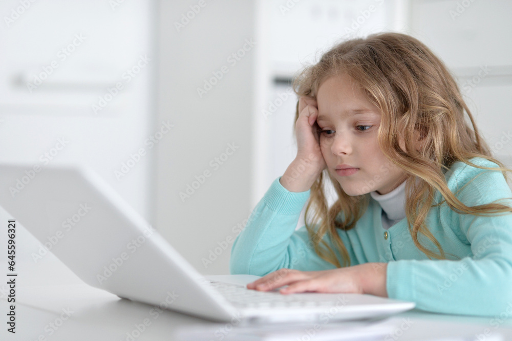 Cute and happy little girl children using laptop computer Cute and happy little girl children using laptop computer