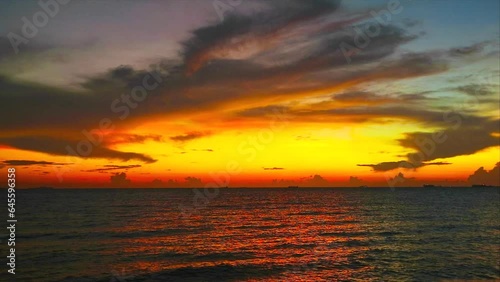 sunset rainbow sky and darkcloud over the sea photo