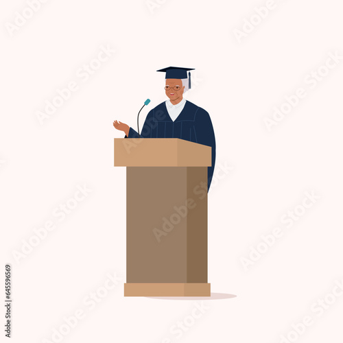 One Smiling Black Senior Woman In Graduate Gown And Mortarboard Standing At A Podium Giving Speech.