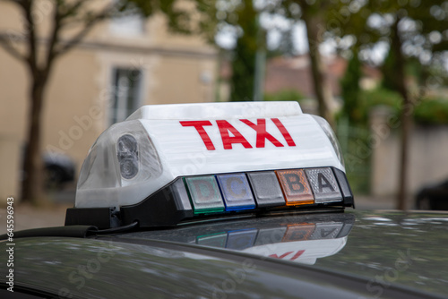 taxi sign on the roof of the car text park on station vehicle