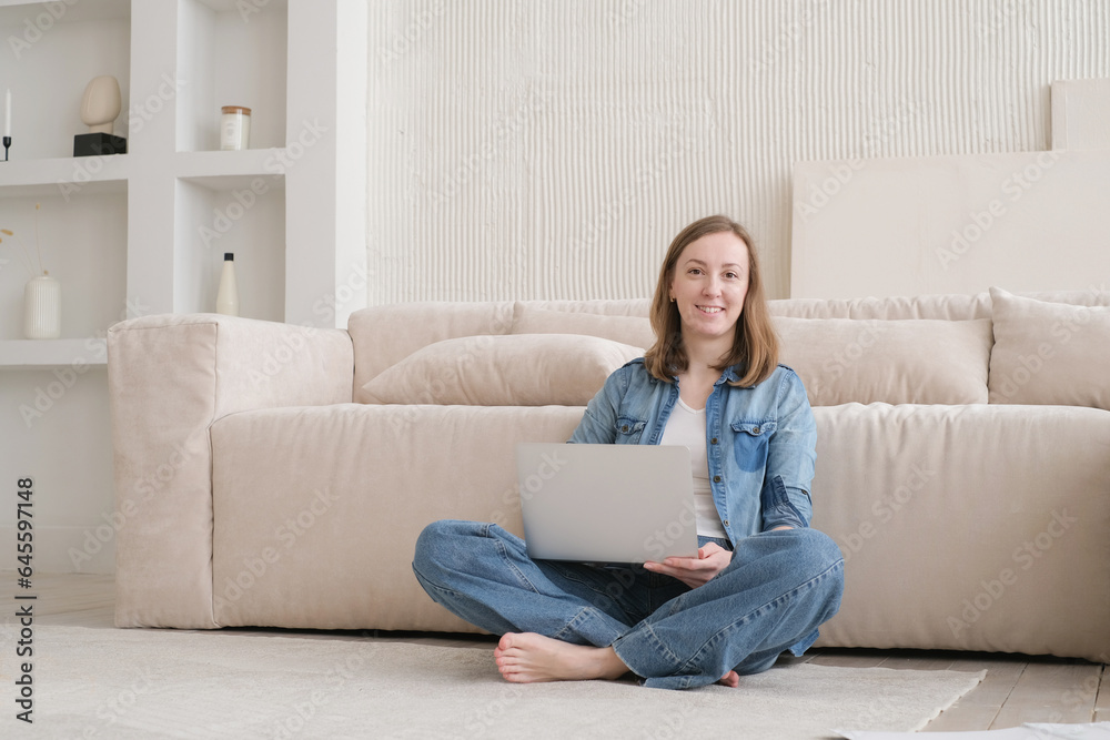 Nice beautiful lady work at the laptop sitting on the sofa at home. technology woman concept for alternative office freelance. Distance home office Nice beautiful lady work at the laptop sitting on the sofa at home. technology woman concept for alternative office freelance. Distance home office