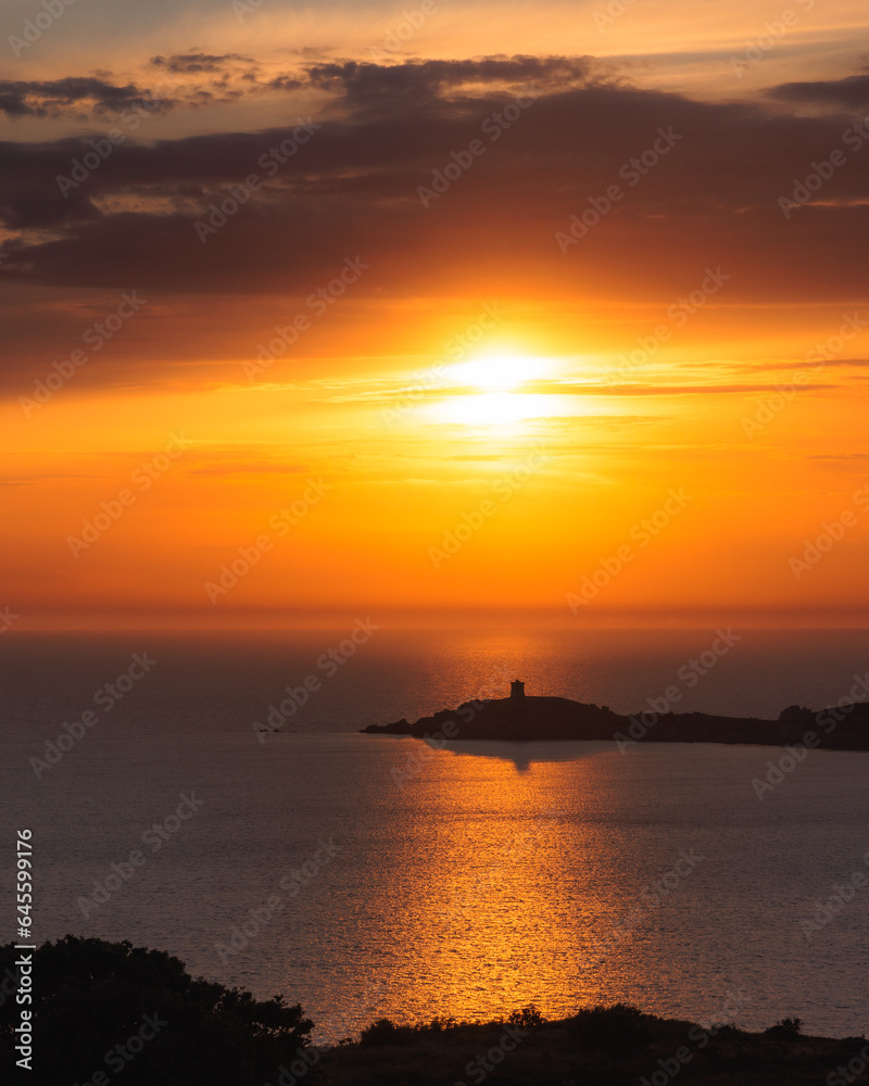 Large view of genoese tower protectecting the Corsican coastline at sunset