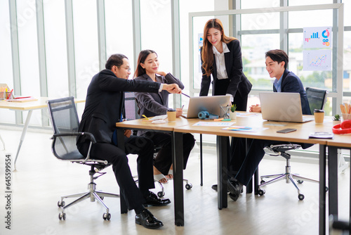 Professional Asian Colleagues in a Contemporary Office Setting, Strategizing for Corporate Growth and Efficiency