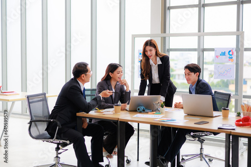 Professional Asian Colleagues in a Contemporary Office Setting, Strategizing for Corporate Growth and Efficiency