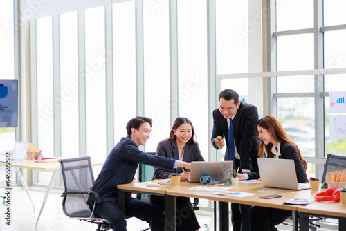 Professional Asian Colleagues in a Contemporary Office Setting, Strategizing for Corporate Growth and Efficiency