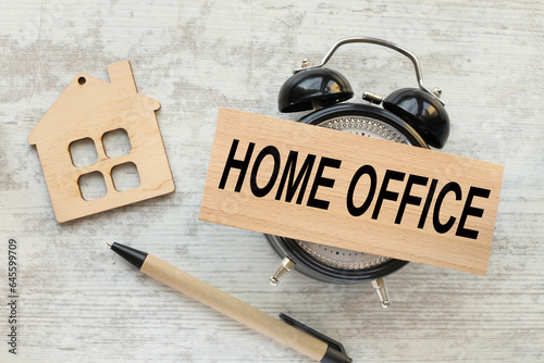 home office concept - table clock gray background.text on wooden block