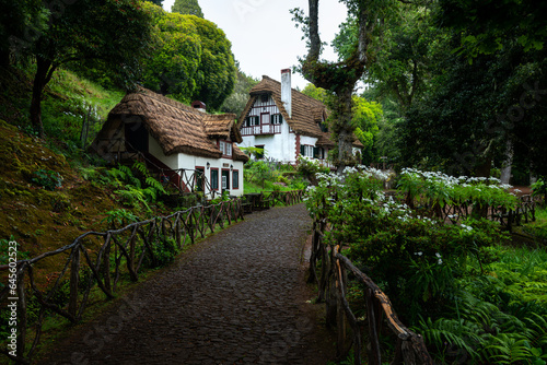 Morning atmosphere by the typical houses in Queimadas Forest Park in Santana, Madeira, starting point to the Caldeirao Verde levada trail. © VOJTa Herout