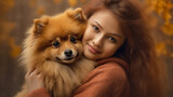 Beautiful Girl hugs her beloved dog - German Spitz, World Animal Day.