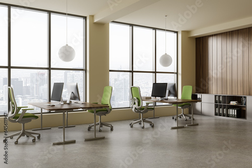 Modern office loft interior with pc monitors and table, shelf and window