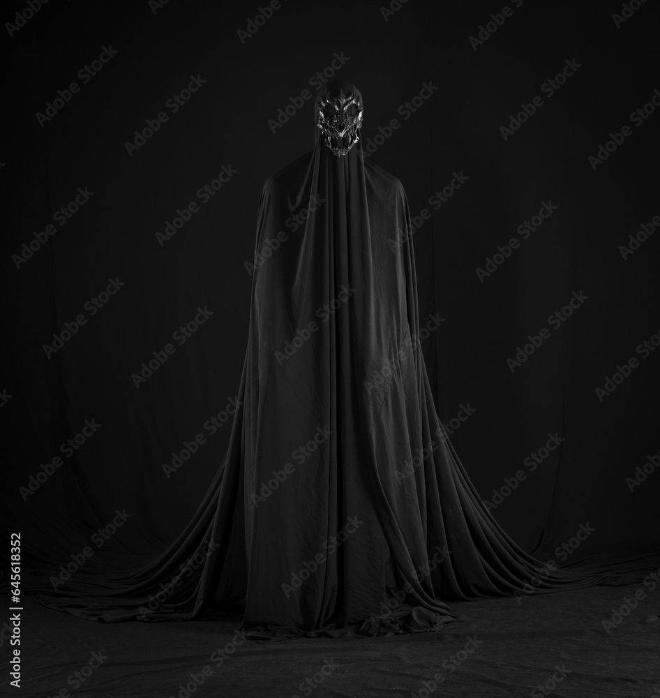 witch in a black cloak on a black background witch in a black cloak on a black background