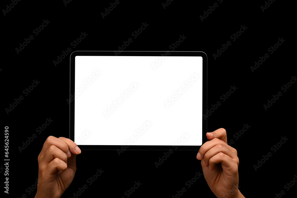 Woman hands holding digital tablet on black background. Blank screen for your text message or promotional content Woman hands holding digital tablet on black background. Blank screen for your text message or promotional content